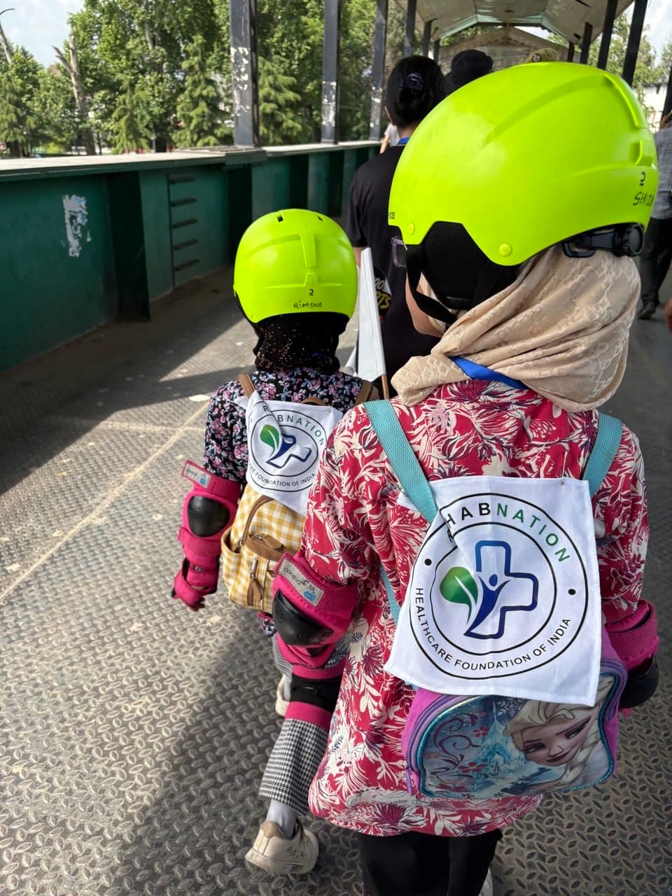 Children wearing RehabNation branded bags at community event